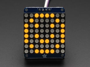Adafruit Small 1.2" 8x8 Yellow LED Matrix w/I2C Backpack assembled and powered on. A yellow graphic smiley is displayed.