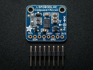 Top down view of  a Triple-axis Accelerometer+Magnetometer (Compass) Board above a 8-pin header. 