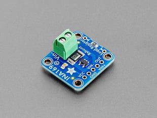 Angled shot of blue, square-shaped breakout board with a green terminal block.