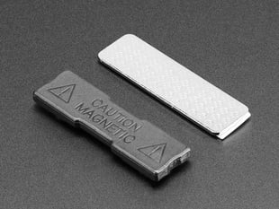 a metal bar with adhesive strip and a plastic piece.