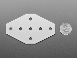 aluminum, 7-holed, cross-plate with U.S. quarter for scale.