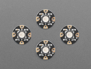 Overhead shot of four, black, round LED breakouts.