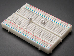 2 white 6mm tactile switch buttons on a breadboard.