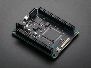 Angled shot of black microcontroller with socket riser headers.