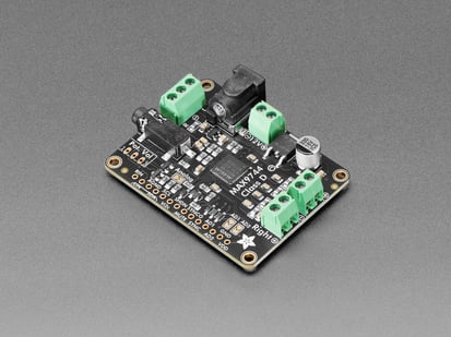 Angled shot of stereo amplifier board with green terminal blocks.