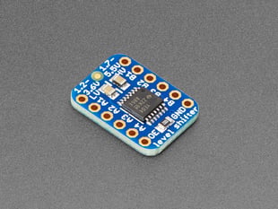 Angled shot of small, blue, rectangular level shifter PCB.