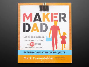 Front cover of "Maker Dad" by Mark Frauenfelder. "Lunch box guitars, antigravity jars, and 22 other incredibly cool father-daughter DIY projects. Cover illustration is of a feature-less father and daughter cartoons.