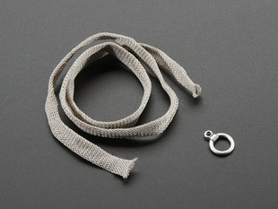 Soft Potentiometer from Plug&Wear next to a silver ring. 