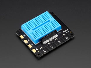 Angled shot of Pimoroni Explorer HAT for Raspberry Pi with a blue mini breadboard.