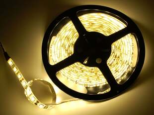 Powered on warm white LED strip on a reel.