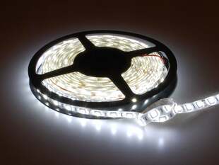 Powered on cool white LED strip on reel.