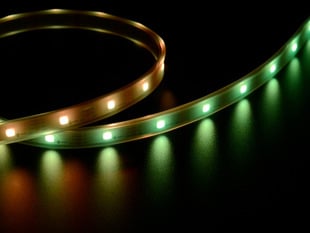 Angled shot of LED strip emitting yellow and green lights.