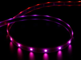 Angled shot of LED strip emitting red and purple lights.