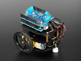 Angled shot of three-layer round robot in black metal with Arduino plus motor shield connected to motors.