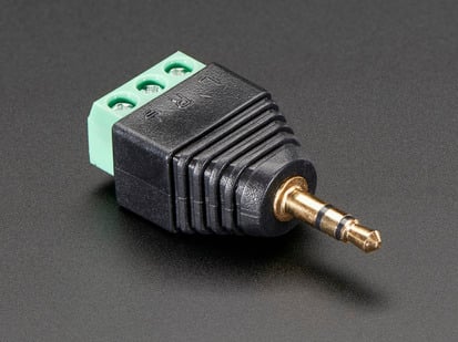 3.5mm stereo audio plug adapter with three green terminal blocks.