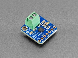 Angled shot of blue, square-shaped, amplifier breakout with a pre-soldered terminal block.