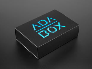 Angled shot of a black box with blue "ADABOX" texted logo.