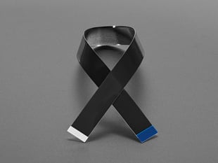 20 centimeter long black, skinny ribbon cable crossed like a bowtie.