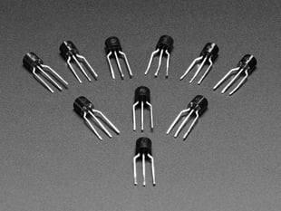 Angled shot of ten black, 3-prong transistors.