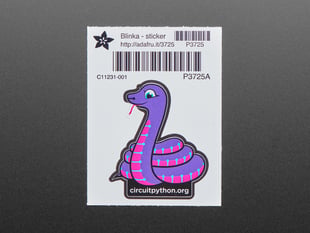 Top Down Shot of the Blinka Sticker. An Animated Purple & Pink Python Character with "circuitpython.org" text below.