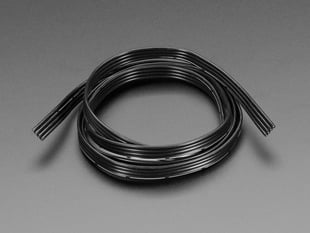 Coiled bundle of black, silicone covered, stranded-core ribbon cable.