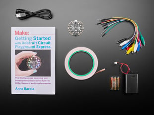 Getting Started with Adafruit Circuit Playground Express book along with a collection of electronic parts included in kit.
