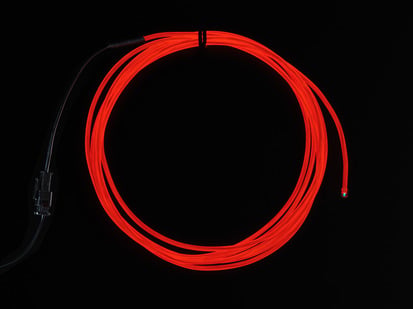 Coil of lit EL wire in red