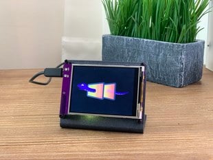 Front view of a Adafruit PyPortal - CircuitPython Powered Internet Display with a pyportal logo image on the display. 