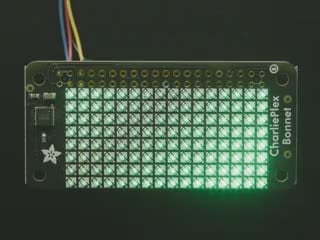 Overhead video of black, rectangular 8x16 LED matrix breakout glowing green LEDs.