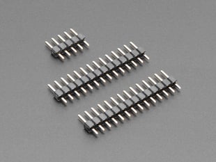 Angled shot of two short 14-pin plug headers and one short 5-pin plug header.