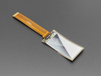 Angled shot of 2.13" monochrome flexible electronic ink display with long ribbon cable with black and white triangles graphic.