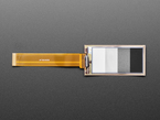 Overhead shot of 2.13" monochrome flexible electronic ink display connected via ribbon cable to a microcontroller. Display is of four blocks in grayscale.