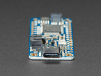 Detailed shot of USB-C port on a blue rectangular microcontroller.
