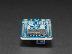 Detailed shot of microSD card holder on a blue rectangular microcontroller. 