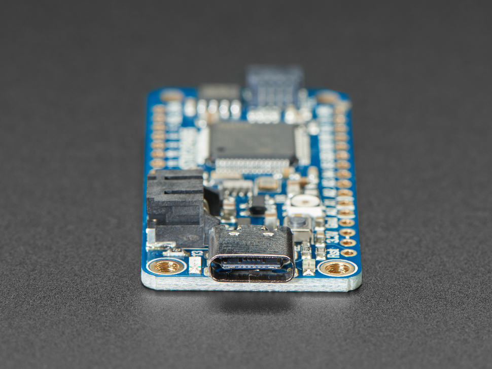 Detailed shot of USB-C port on a blue rectangular microcontroller.