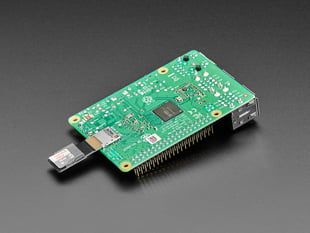Angled Demo Shot of the Micro SD Card PCB Extender inserted into Micro SD Card slot at the bottom of a Raspberry Pi Computer. 