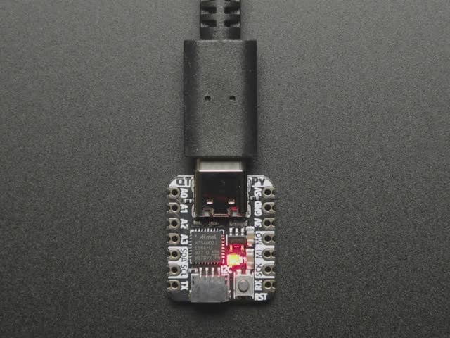 Animation of Adafruit QT Py with onboard NeoPixel in a rainbow swirl.