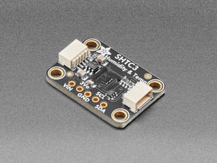 Angled shot of small, black, rectangular humidity and temperature sensor breakout.