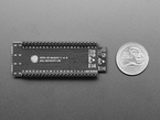 Top Down Bottom Shot of the ESP32-S2 Saola 1R Dev Kit featuring ESP32-S2 WROVER next to a U.S. Quarter for Scale.