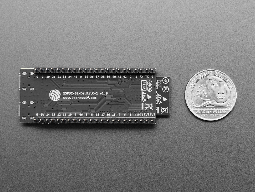 Top Down Bottom Shot of the ESP32-S2 Saola 1R Dev Kit featuring ESP32-S2 WROVER next to a U.S. Quarter for Scale.