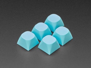 Angled shot of five cyan keycaps.