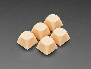 Angled shot of five cream orange MA keycaps. 