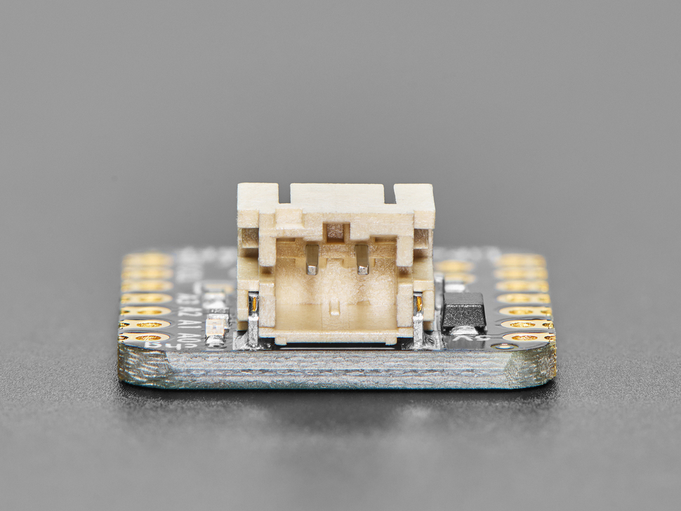 Close-up of JST-PH connector on small, black, square-shaped breakout board.