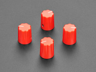 Angled shot of four red micro potentiometer knobs.