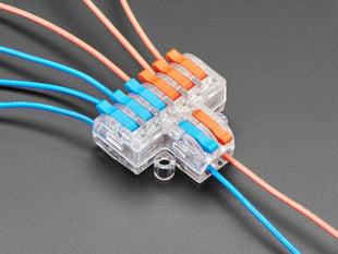 Angled shot of clear 2-to-6 Wiring Block Connector assembled with blue and red wires.