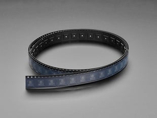 Angled shot of long black plastic reel with 100 microchips.