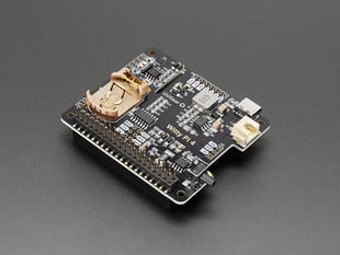 Angled shot of black, square-shaped Raspberry Pi power management add-on board.