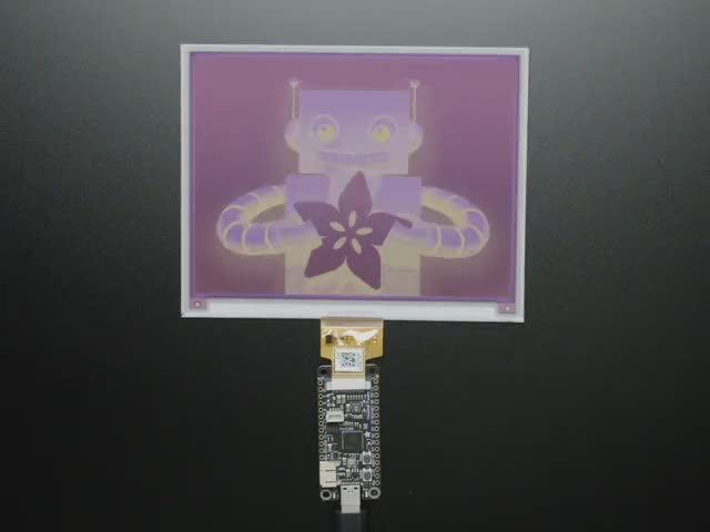 Overhead video of a rectangular microcontroller powering a big e-ink display.