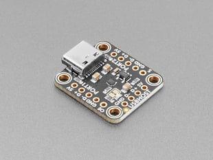 Angled shot of black, square breakout board with a USB-C connector.