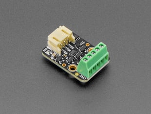 Angled shot of rectangular RGB LED driver board with green terminal blocks.